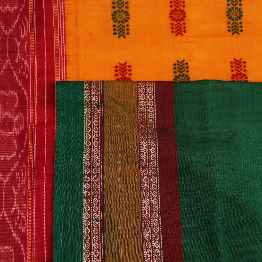 Full view of a white and green cotton handloom Bomkai saree with butta pattern.