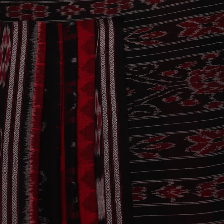 Red and black Sambalpuri cotton saree draped, showcasing overall styling and motifs.