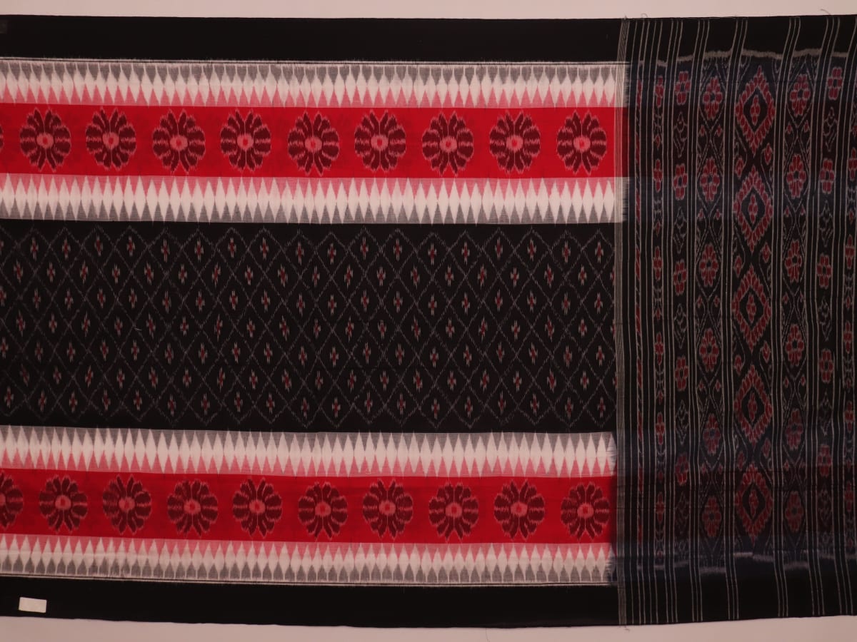 Saree styling: A red and black Sambalpuri cotton handloom saree with motifs is beautifully draped.