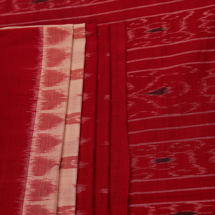 Cream and red Sambalpuri cotton saree with motifs elegantly draped on a person.