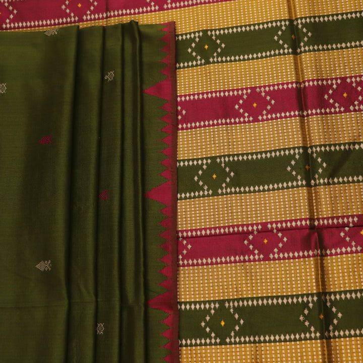 Close-up of the textured green Sambalpuri Silk Saree fabric, highlighting the woven butta pattern.