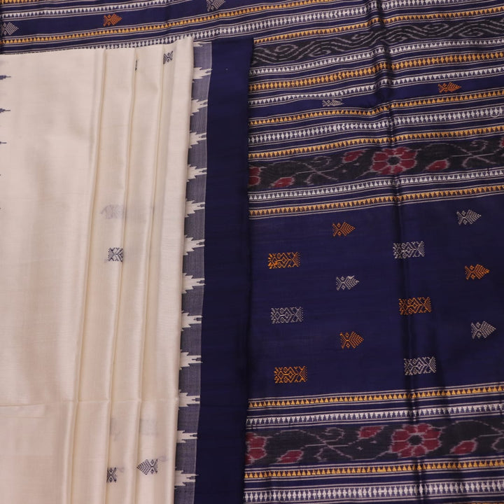 Close-up of white and blue Sambalpuri Silk Saree fabric texture, highlighting butta pattern.