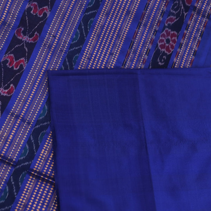 Close-up of plain blue Sambalpuri silk handloom saree fabric texture.