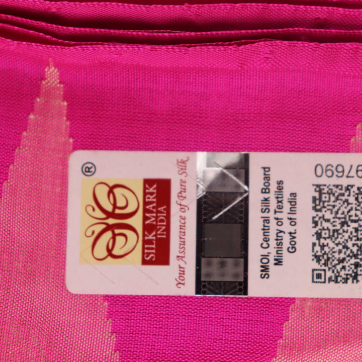 Close-up of plain peach and pink Sambalpuri silk saree fabric texture.