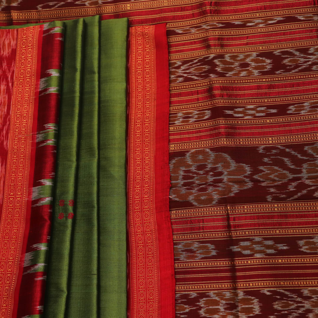 Green Khandua silk saree draped, showcasing its butta pattern and red accents.