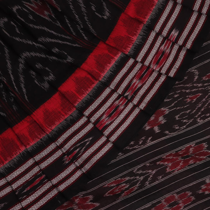 Red and black Sambalpuri cotton saree draped, showcasing overall styling and motifs.