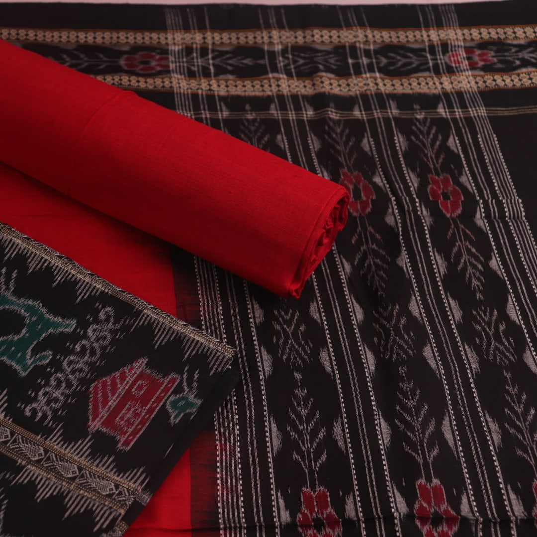 Detail of the black Sambalpuri cotton dress material's blouse piece with red motifs.