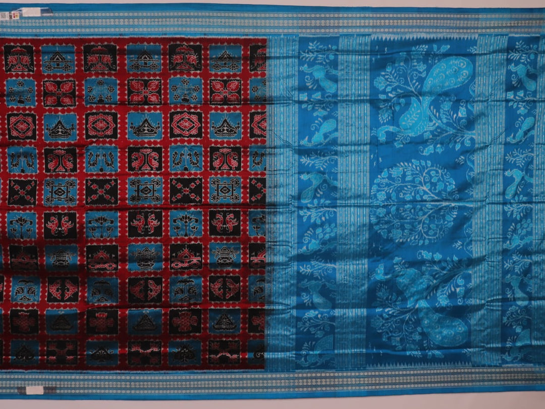 Close-up of multi-color Sambalpuri silk saree fabric showing texture and woven motifs; secondary color blue visible.