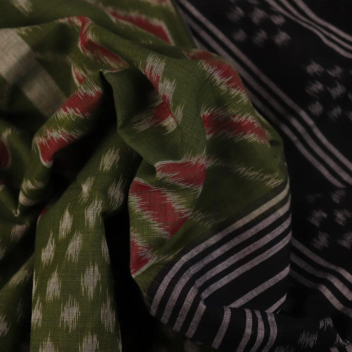 Green and black Sambalpuri cotton saree with motifs, elegantly draped.