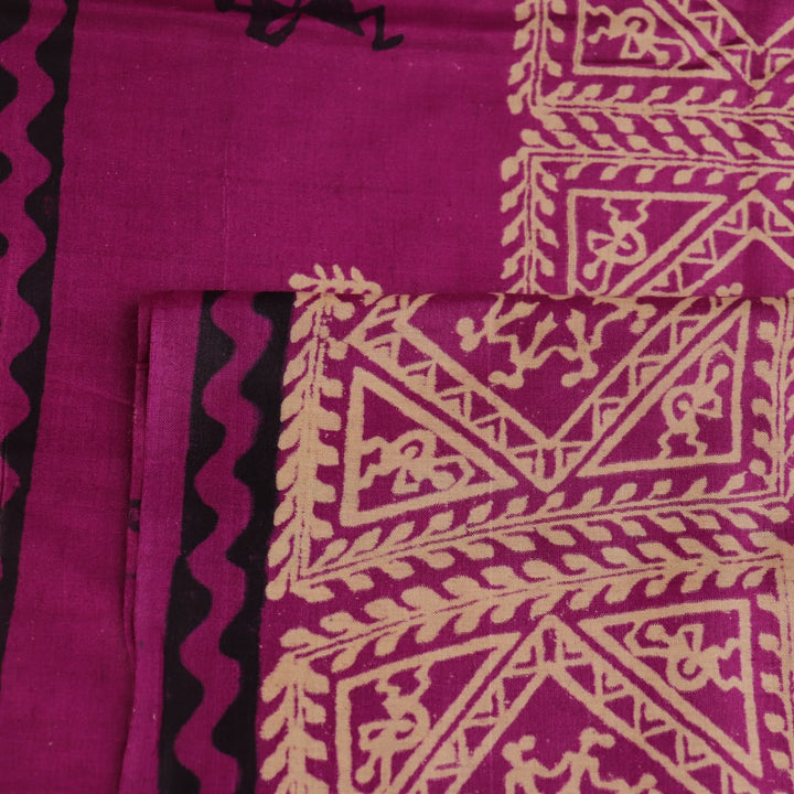 Close-up of magenta Tussar silk saree fabric, showing the printed pattern and natural slub texture.