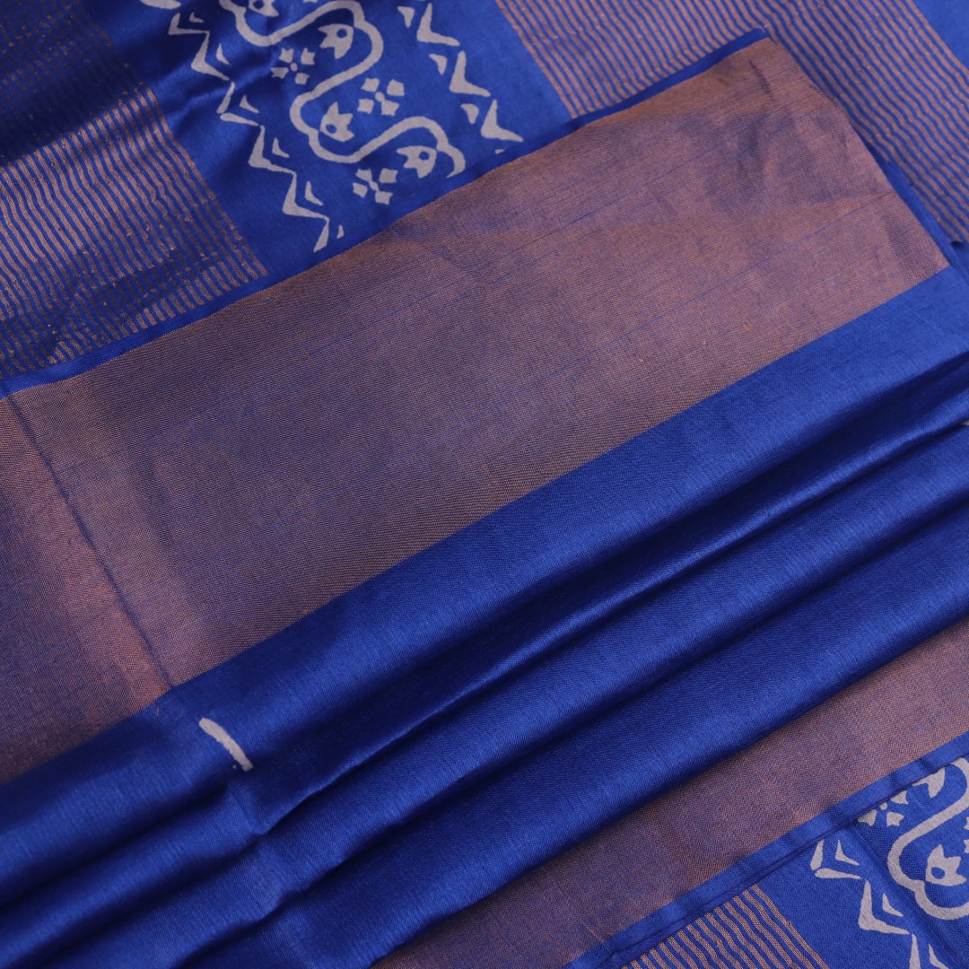 Close-up of blue printed Tussar silk handloom saree fabric texture.