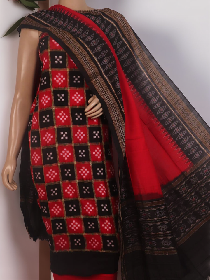 Detail of the black Sambalpuri cotton Pasapalli dress material's blouse piece with red accents.