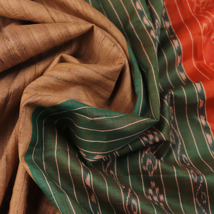 Close-up of plain off-white Tussar silk saree fabric, showing natural slub texture and rust weave.