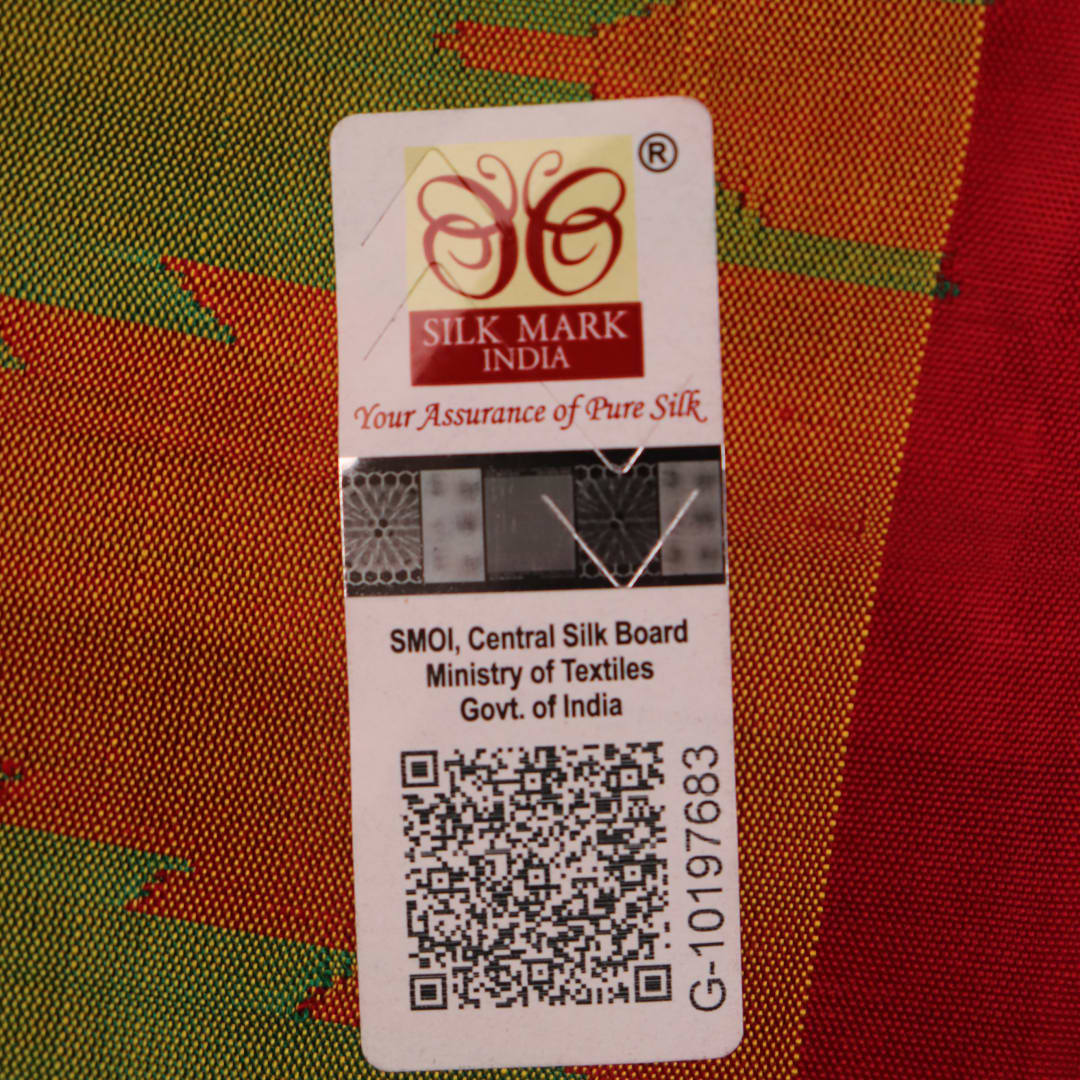 Close-up of plain green Sambalpuri silk saree fabric texture.