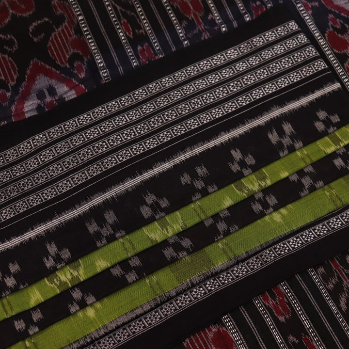 Styled green and black cotton Sambalpuri handloom saree with motifs, showcasing its elegant drape.