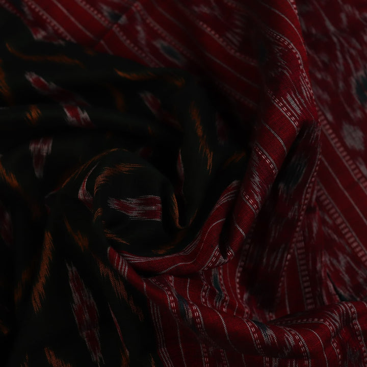 Black and red Sambalpuri cotton saree draped, showcasing its traditional motifs and elegant handloom texture.