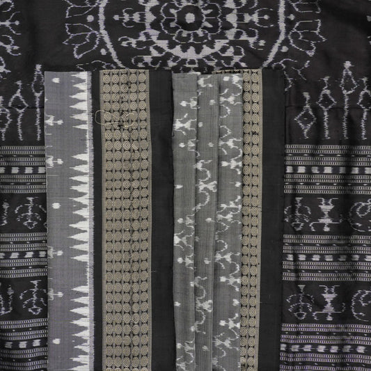 Close-up of grey & black Sambalpuri silk saree fabric, highlighting its rich texture and weave.