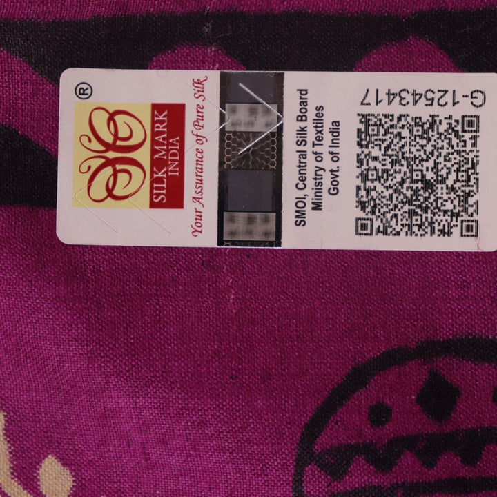 Close-up of magenta Tussar silk saree fabric, showing the printed pattern and natural slub texture.