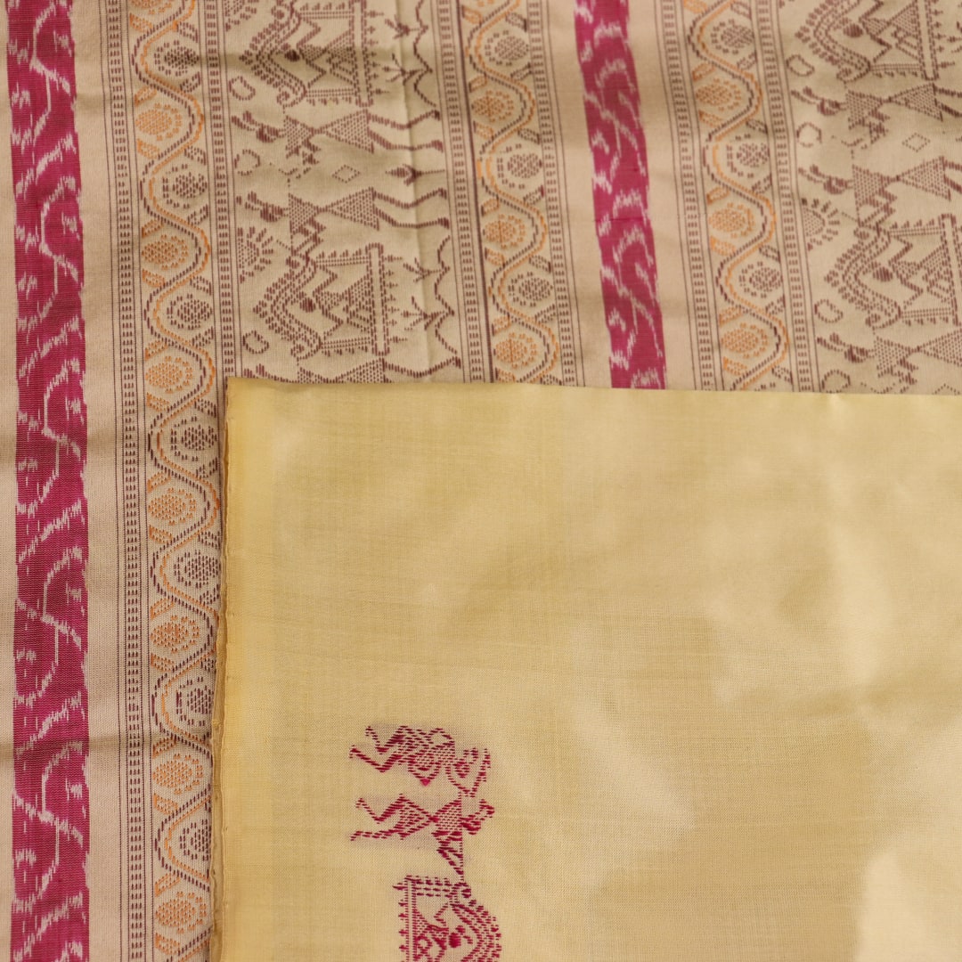 Close-up texture of pink and cream handloom Bomkai silk saree with butta pattern.
