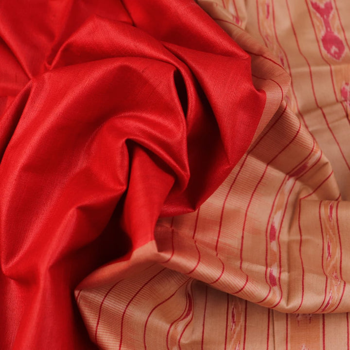 Close-up of plain red and off-white Tussar silk saree fabric texture.