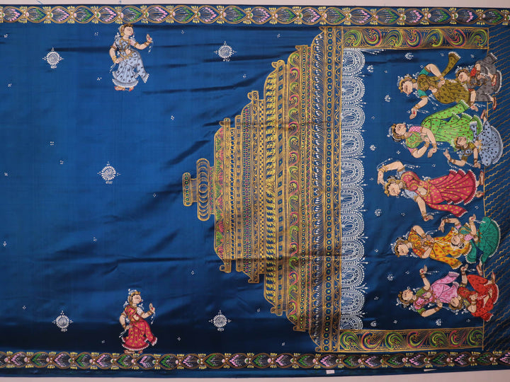 Close-up of handloom blue silk Patachitra saree fabric, showcasing the fine texture and hand-painted details.
