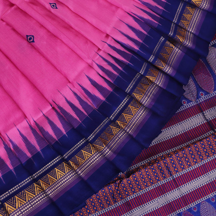 Close-up of pink and blue Dongria Silk Saree fabric texture with butta pattern.