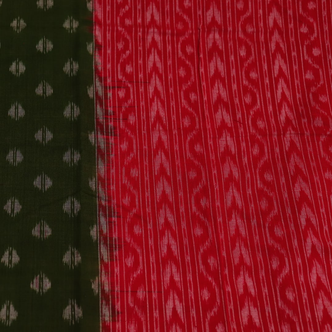 A woman wearing a green and red cotton Sambalpuri dupatta with motifs draped over her shoulder