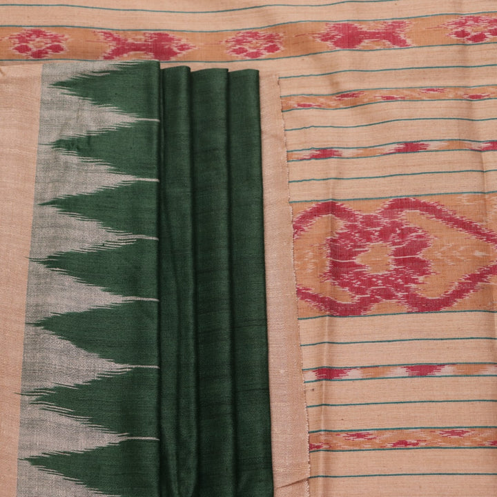 Close-up of the green and off-white plain Tussar silk saree, highlighting its natural slub texture.