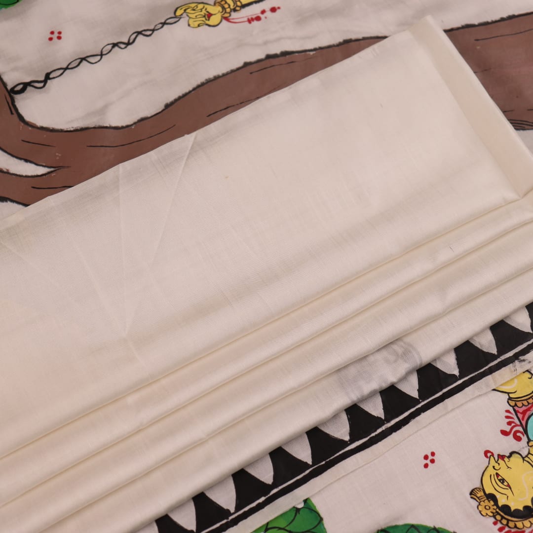Close-up of white silk Patachitra saree fabric showing hand-painted texture and detail.