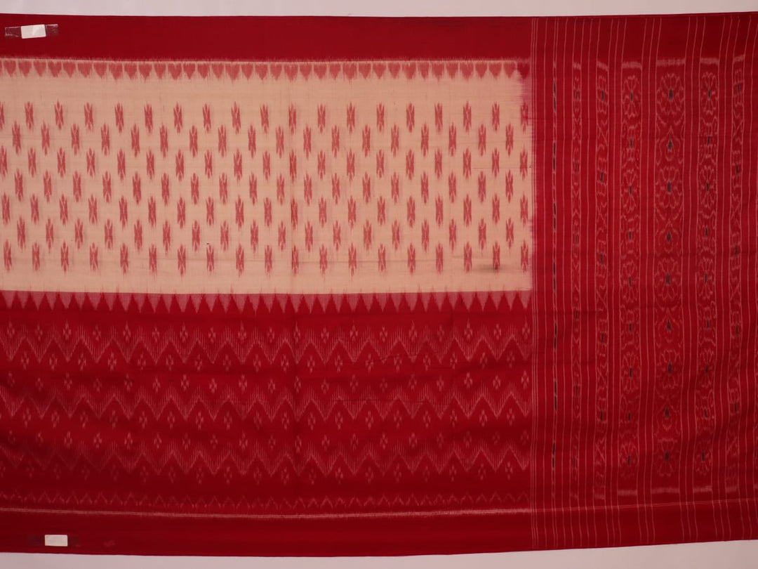 Cream and red Sambalpuri cotton saree with motifs elegantly draped on a person.