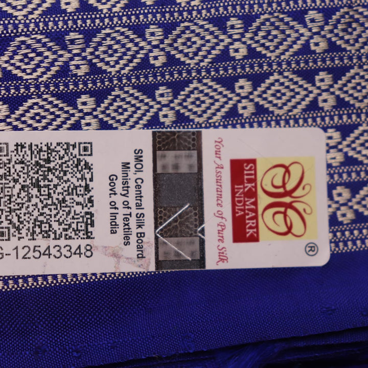Close-up of green and blue Sambalpuri silk saree fabric showing intricate handloom weave and motif details.
