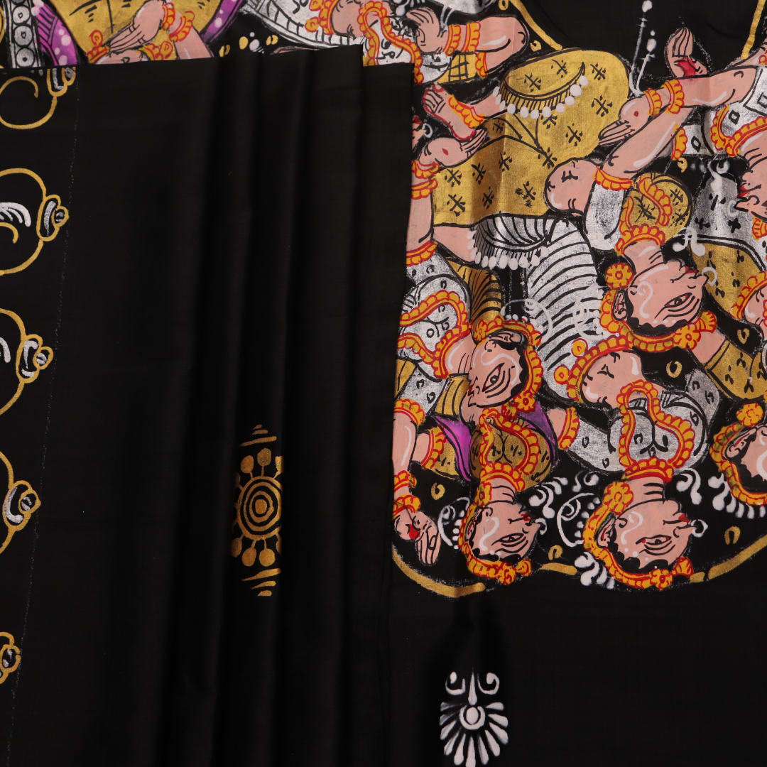 Close-up of black silk Patachitra saree fabric, showcasing hand-painted texture and detail.