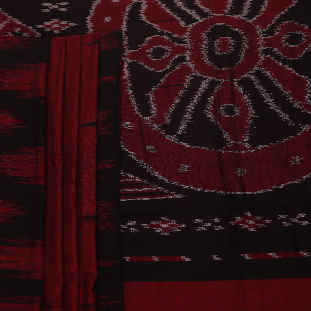 Gracefully draped maroon and black plain Sambalpuri cotton saree.