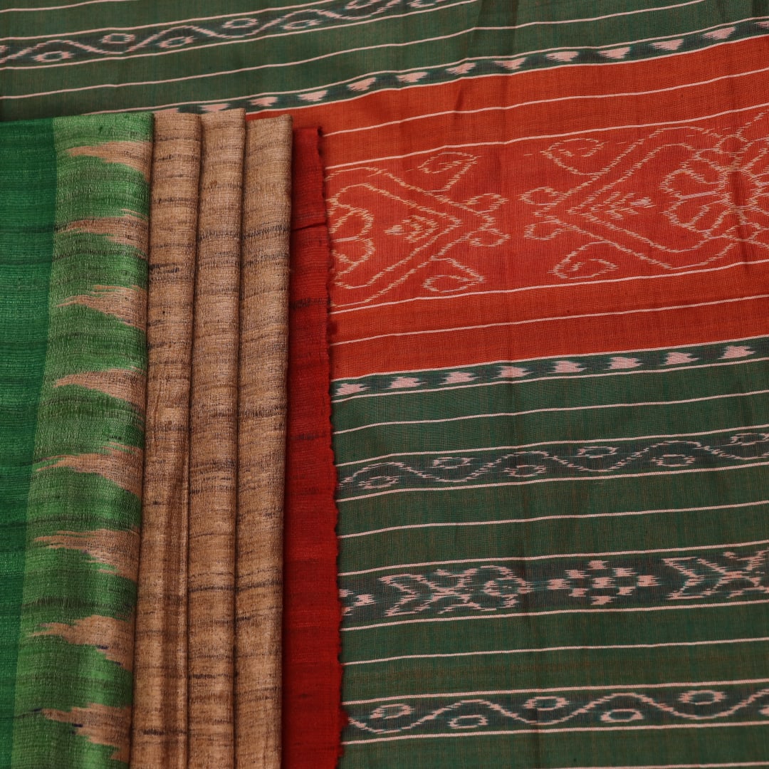 Close-up of plain off-white Tussar silk saree fabric, showing natural slub texture and rust weave.