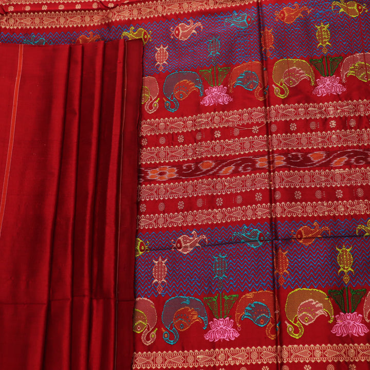 Close-up of maroon plain Sambalpuri silk saree fabric texture.