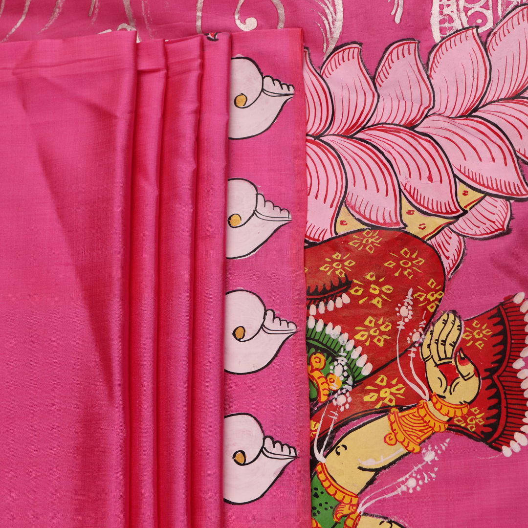 Close-up of pink silk Patachitra saree fabric, showcasing hand-painted texture and fine details.
