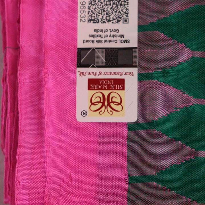 Close-up of plain green and pink Sambalpuri silk saree fabric texture.
