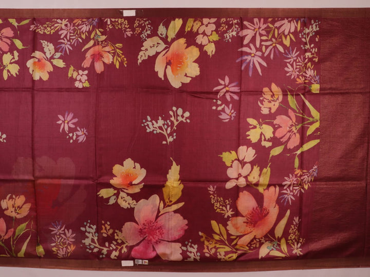 Close-up of maroon Tussar silk saree fabric, emphasizing its distinct texture and printed pattern.