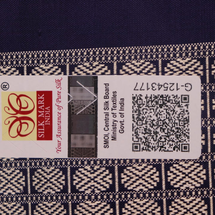 Close-up fabric texture of a blue Bomkai silk saree, revealing intricate butta pattern weave.