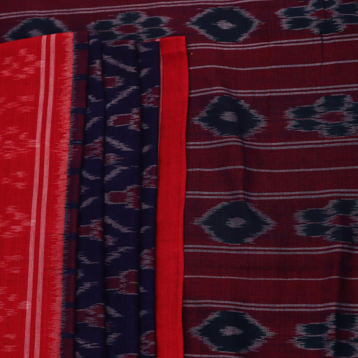 Gracefully draped blue Sambalpuri cotton saree with red motifs, highlighting its design and flow.