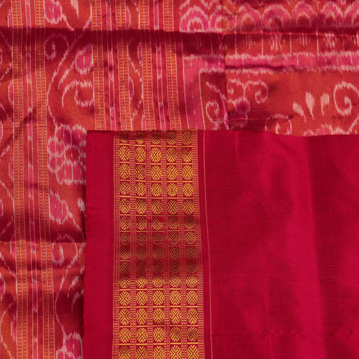 Close-up of black Sambalpuri silk saree fabric texture with subtle motifs and magenta threads.