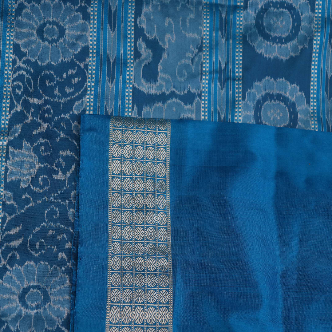 Close-up of black Sambalpuri silk saree fabric texture, showcasing the weave and subtle motif details.