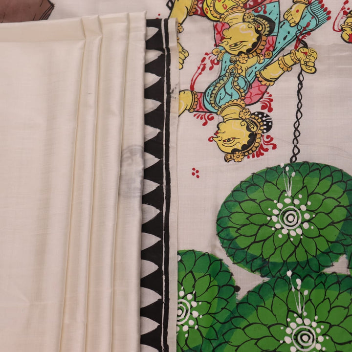 Close-up of white silk Patachitra saree fabric showing hand-painted texture and detail.