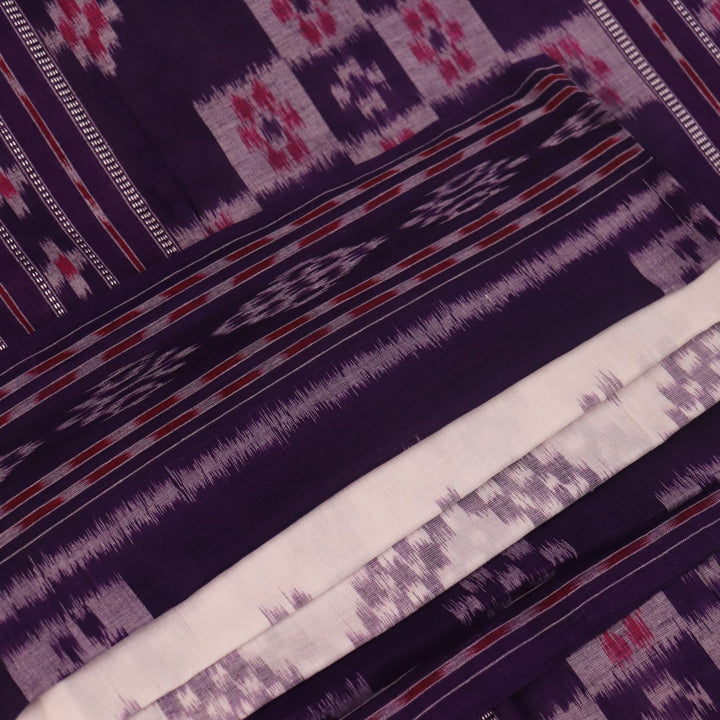 Elegantly draped red and violet Sambalpuri cotton saree with traditional motifs.