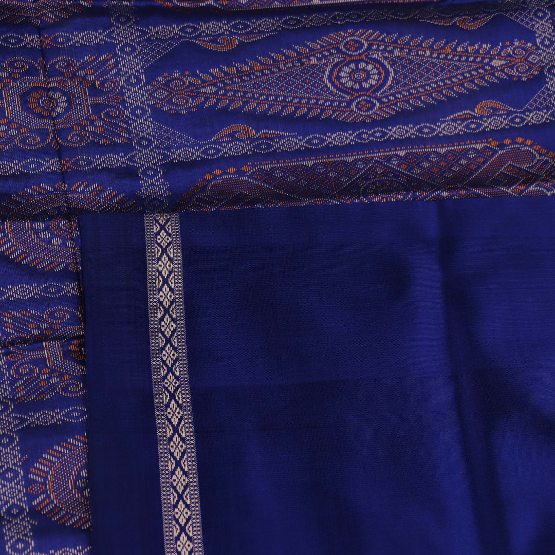 Textured close-up of yellow Bomkai silk saree fabric with blue butta pattern.