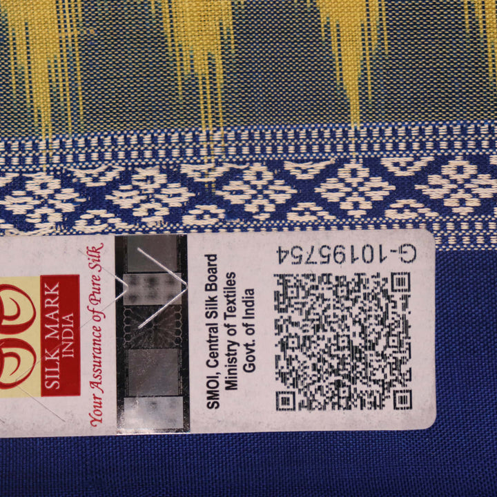 Textured close-up of yellow Bomkai silk saree fabric with blue butta pattern.