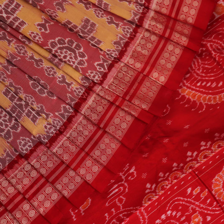 Close-up of multicolored silk Sambalpuri saree fabric showing intricate handloom weave texture.