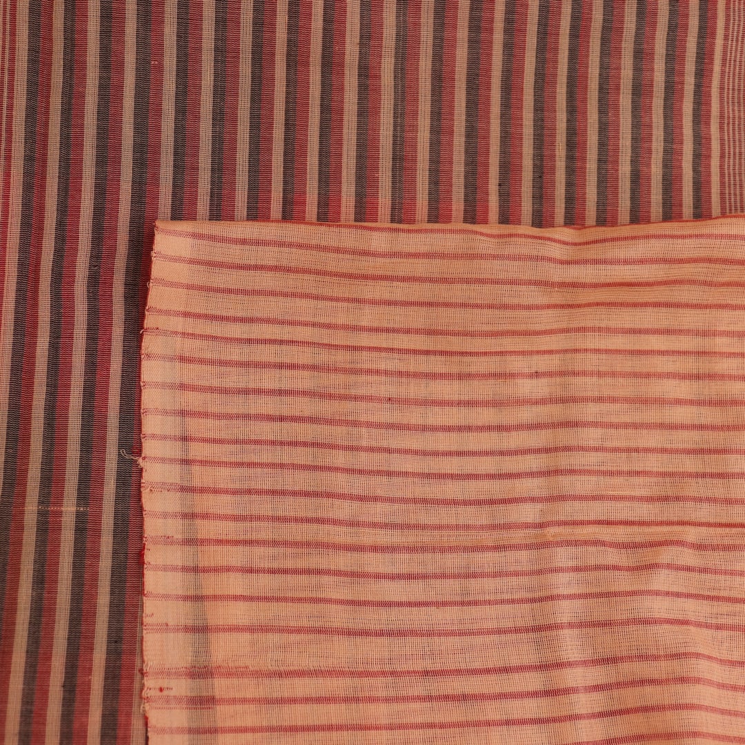 Full product view of a red and cream Sambalpuri cotton saree featuring traditional motifs.