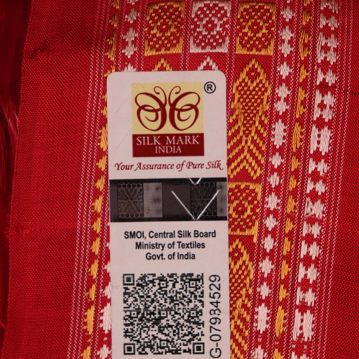 Close-up of the distinct handwoven texture of a red Sambalpuri silk saree with Butta pattern.