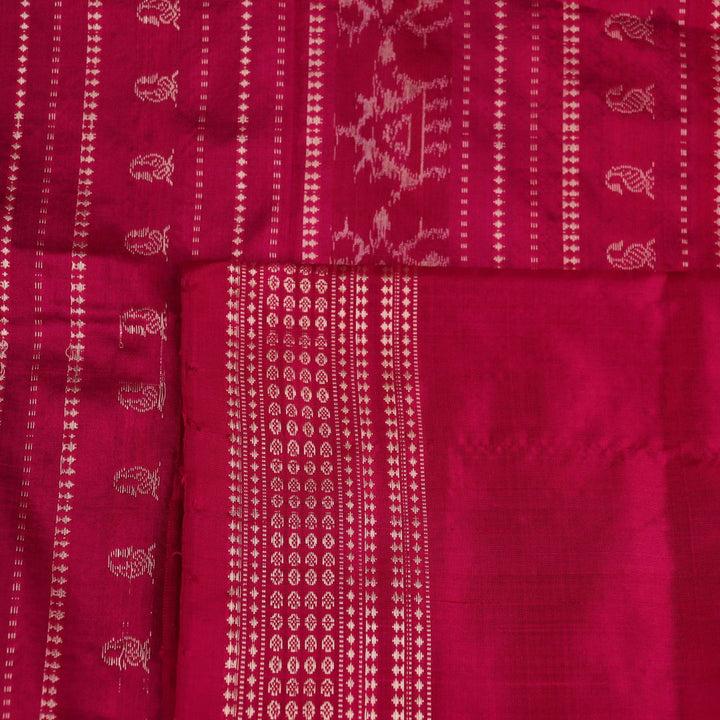Close-up of textured green Sambalpuri silk saree fabric with magenta motifs.